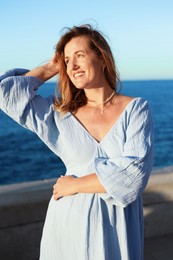 Photo of Beautiful woman near sea on summer day