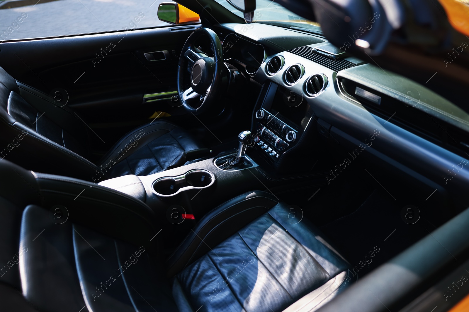 Photo of Interior of modern cabriolet parked outdoors, closeup