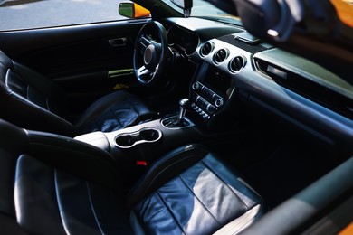 Photo of Interior of modern cabriolet parked outdoors, closeup
