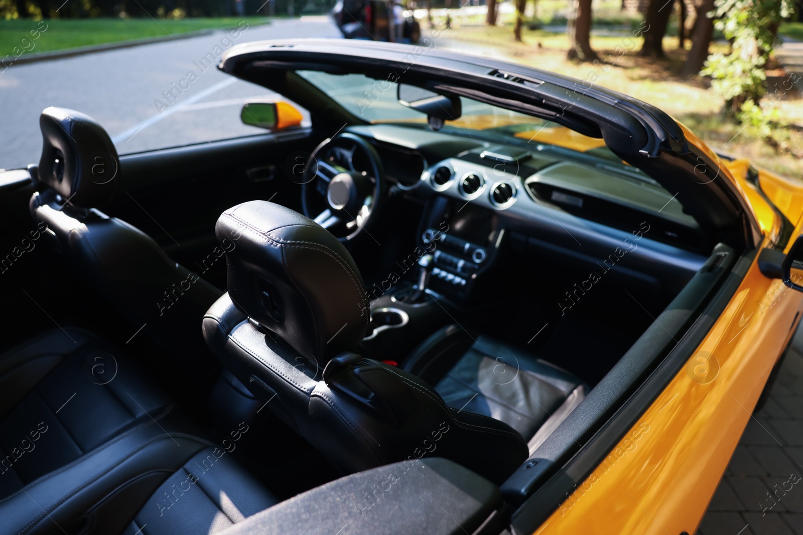 Photo of Modern cabriolet parked on parking lot outdoors, closeup