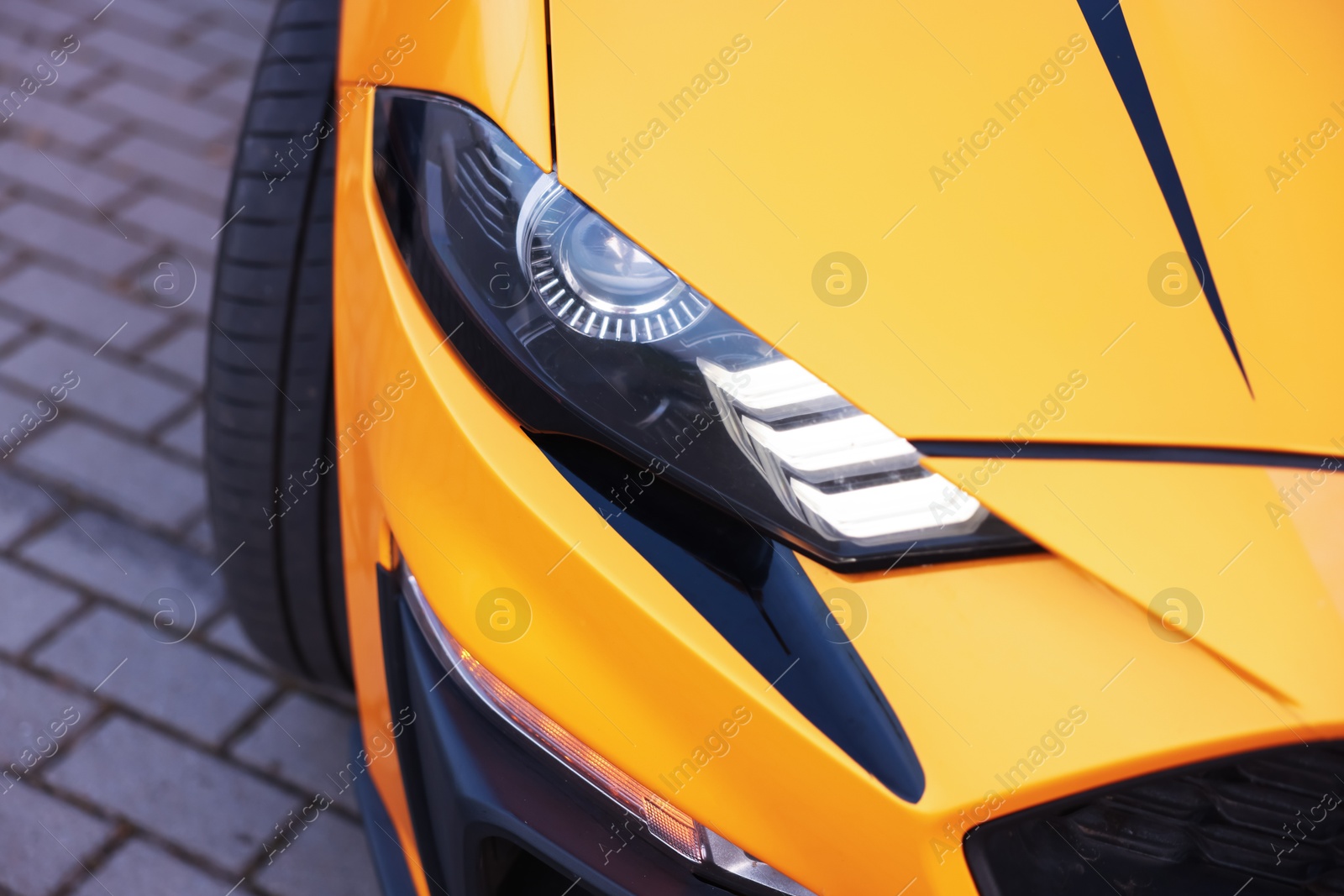 Photo of Modern cabriolet parked on parking lot outdoors, closeup