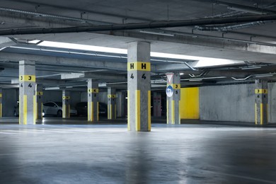 Photo of View of empty underground parking with dedicated spots
