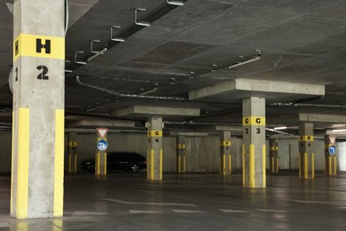 Photo of View of empty underground parking with dedicated spots