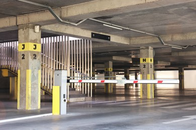 Photo of Underground parking with bar gate, dedicated spots, pedestrian crossing and stairs