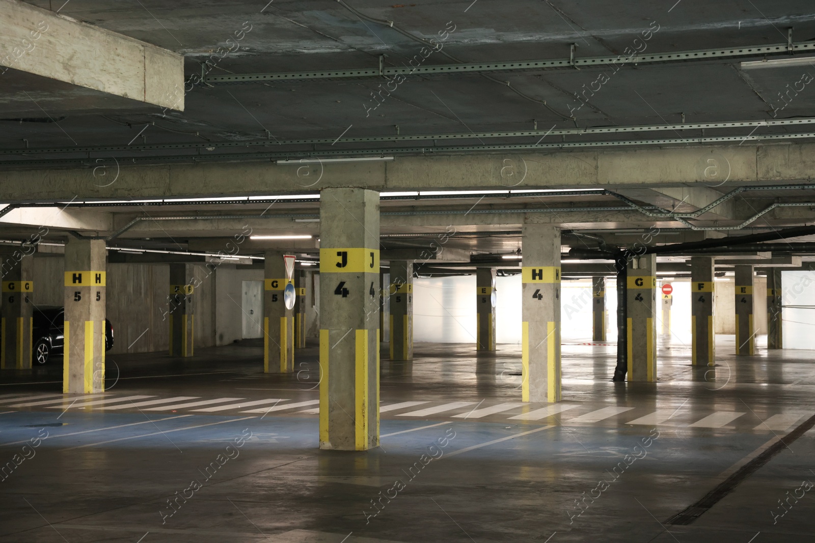 Photo of Underground parking with dedicated spots, pedestrian crossing and cars