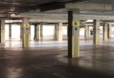 Photo of View of empty underground parking with dedicated spots