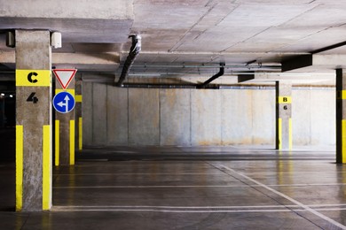 Photo of View of empty underground parking with dedicated spots
