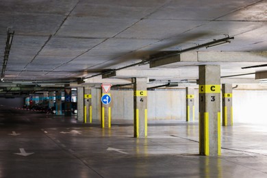 Photo of View of empty underground parking with dedicated spots