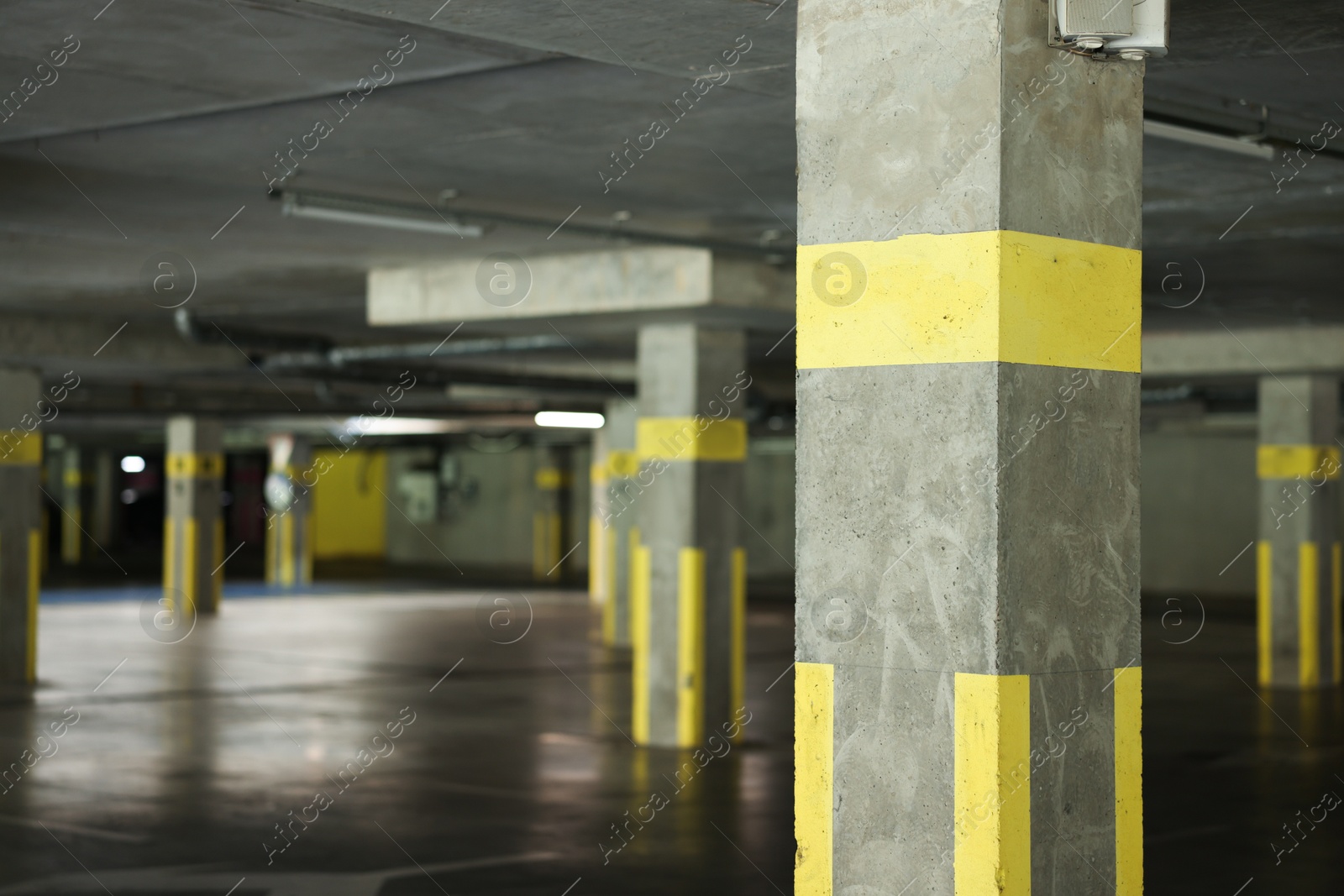 Photo of View of empty underground parking with dedicated spots