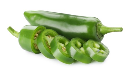 Photo of Whole and sliced green jalapeno peppers isolated on white