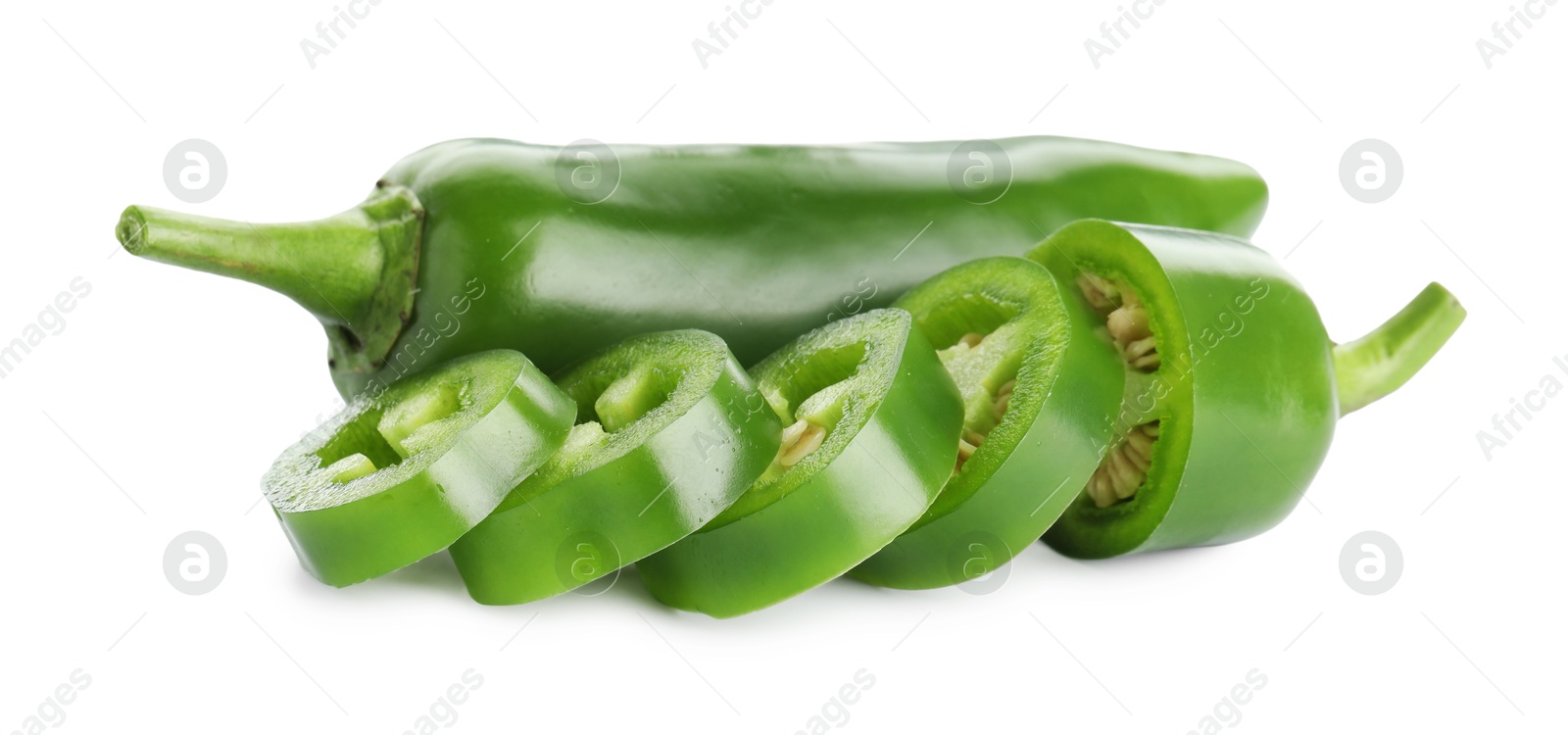 Photo of Whole and sliced green jalapeno peppers isolated on white