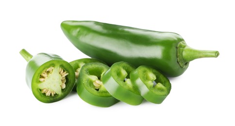 Photo of Whole and sliced green jalapeno peppers isolated on white