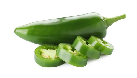 Photo of Whole and sliced green jalapeno peppers isolated on white