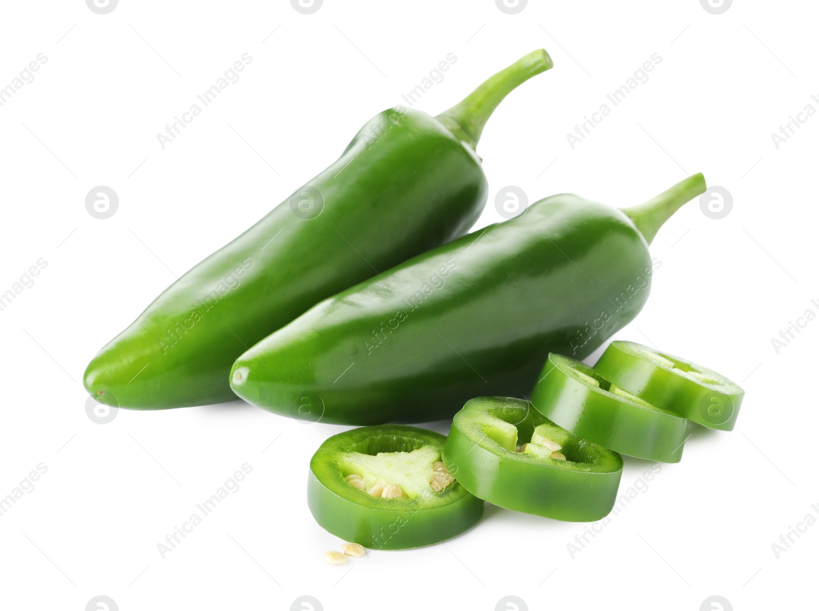 Photo of Whole and sliced green jalapeno peppers isolated on white