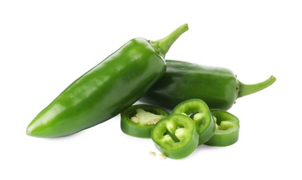 Photo of Whole and sliced green jalapeno peppers isolated on white