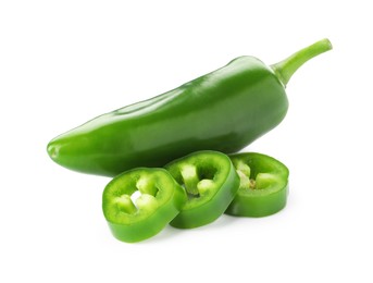 Photo of Whole and sliced green jalapeno peppers isolated on white