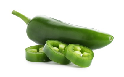 Photo of Whole and sliced green jalapeno peppers isolated on white