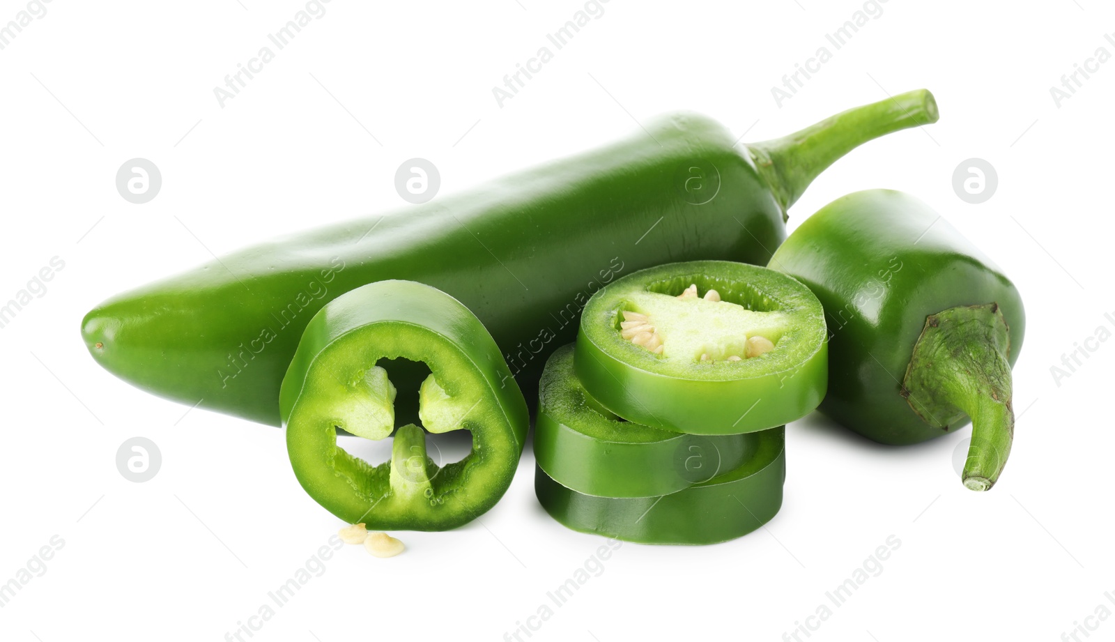 Photo of Whole and sliced green jalapeno peppers isolated on white