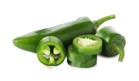 Photo of Whole and sliced green jalapeno peppers isolated on white