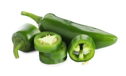 Photo of Whole and sliced green jalapeno peppers isolated on white