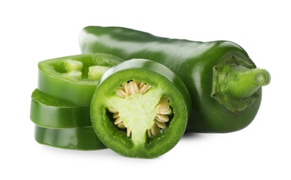 Photo of Whole and sliced green jalapeno peppers isolated on white