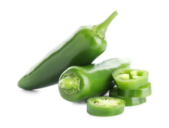 Photo of Whole and sliced green jalapeno peppers isolated on white