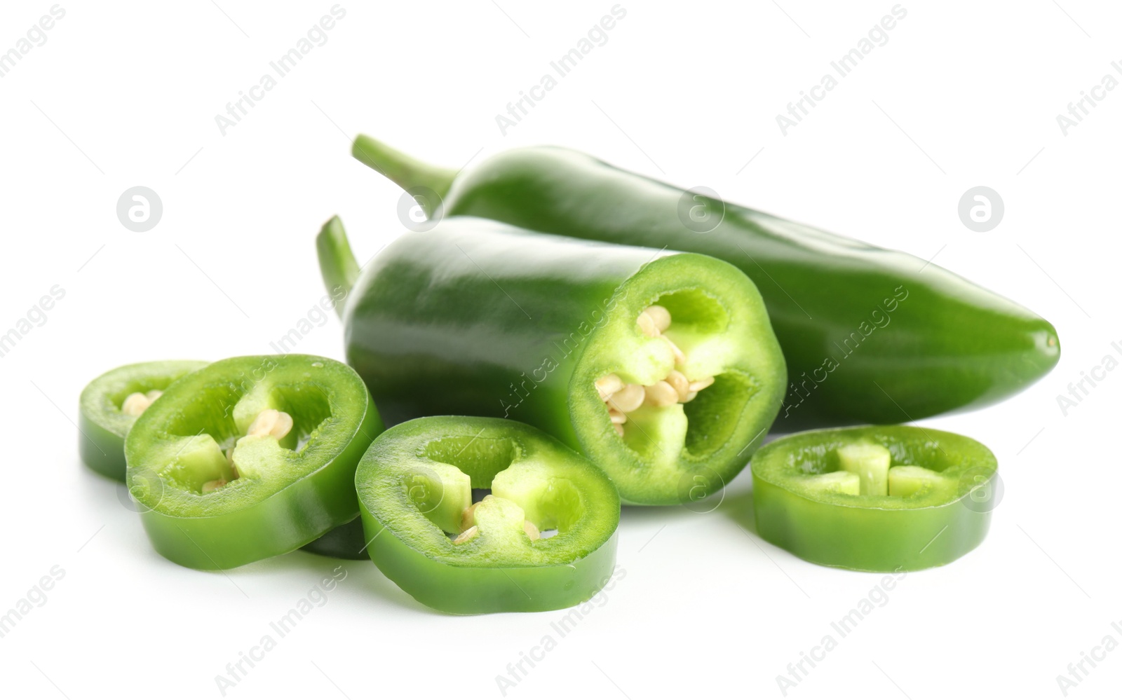 Photo of Whole and sliced green jalapeno peppers isolated on white