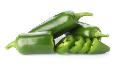 Photo of Whole and sliced green jalapeno peppers isolated on white