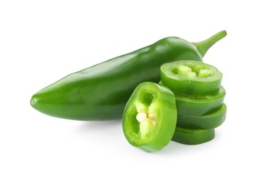 Photo of Whole and sliced green jalapeno peppers isolated on white