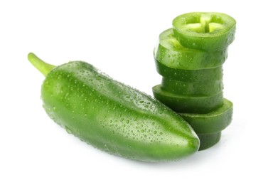 Photo of Whole and sliced green jalapeno peppers isolated on white