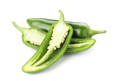 Photo of Whole and cut green jalapeno peppers isolated on white