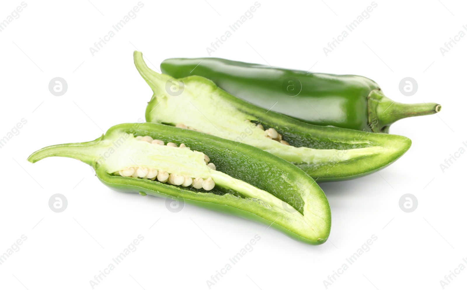 Photo of Whole and cut green jalapeno peppers isolated on white