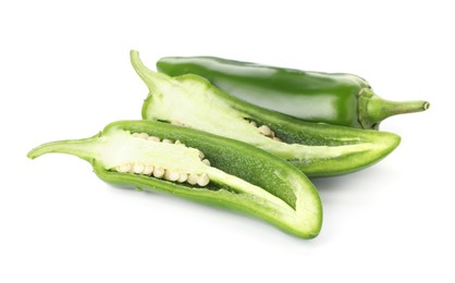 Photo of Whole and cut green jalapeno peppers isolated on white