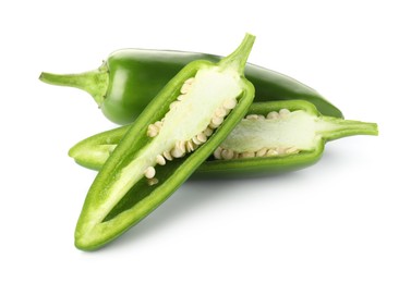 Photo of Whole and cut green jalapeno peppers isolated on white