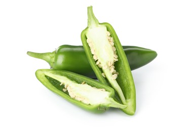 Photo of Whole and cut green jalapeno peppers isolated on white