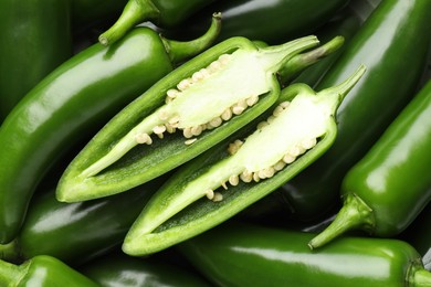 Photo of Fresh green jalapeno peppers as background, top view