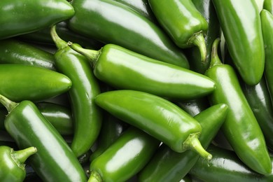 Photo of Fresh green jalapeno peppers as background, top view