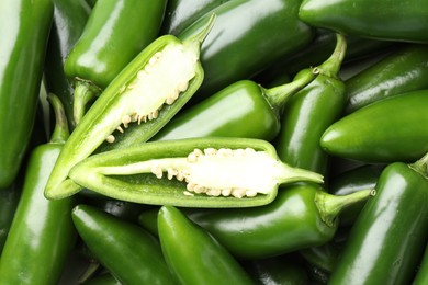 Photo of Fresh green jalapeno peppers as background, top view
