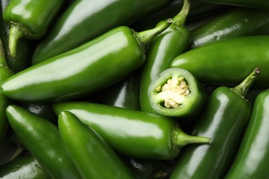 Photo of Fresh green jalapeno peppers as background, closeup