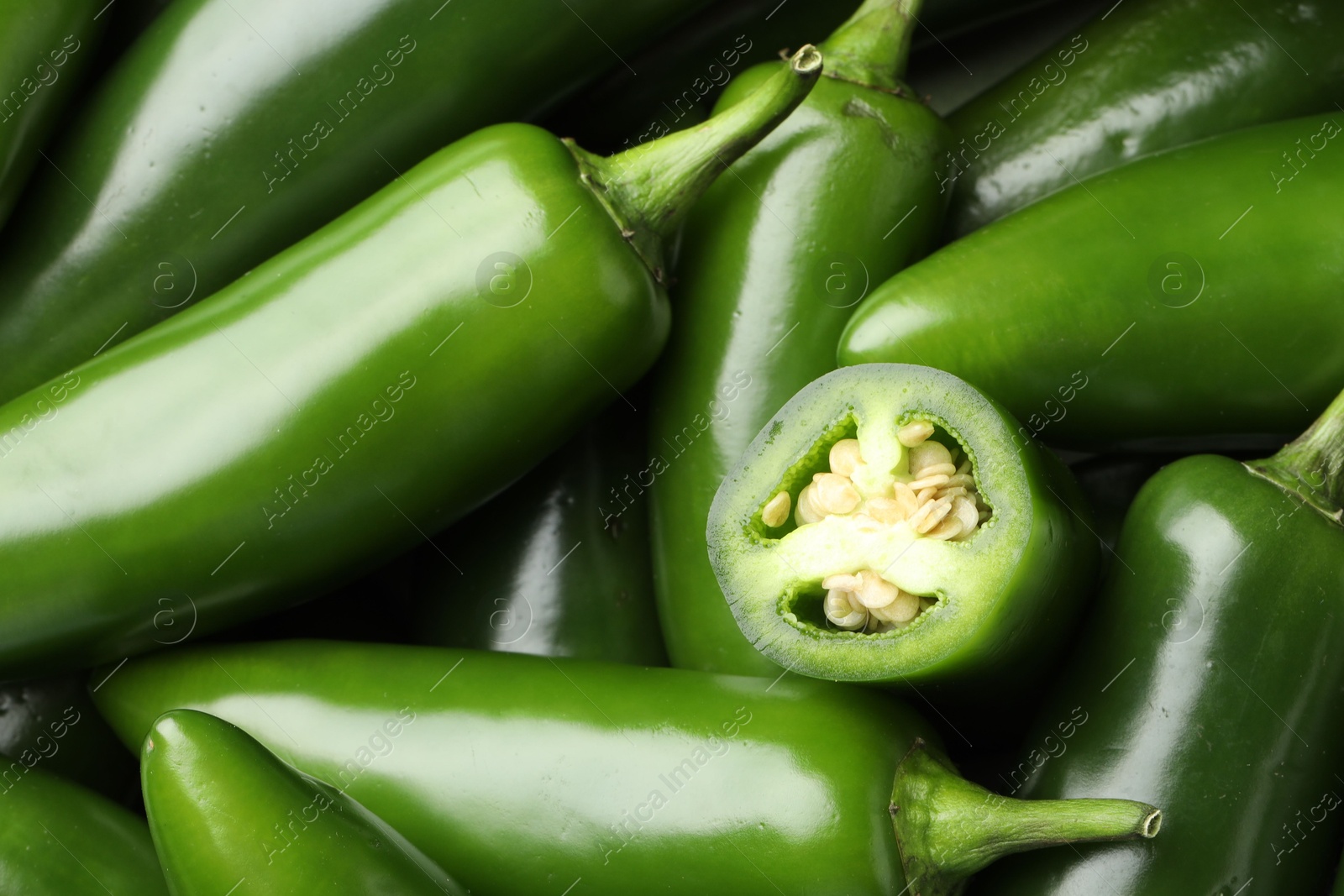 Photo of Fresh green jalapeno peppers as background, closeup