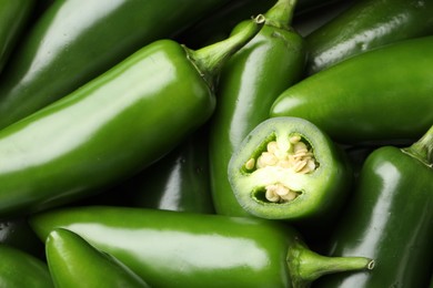 Photo of Fresh green jalapeno peppers as background, closeup