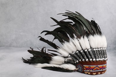 Photo of Traditional warbonnet (Native American chief headdress) on light grey table
