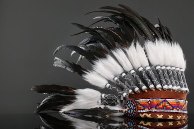 Photo of Traditional warbonnet (Native American chief headdress) on black mirror surface