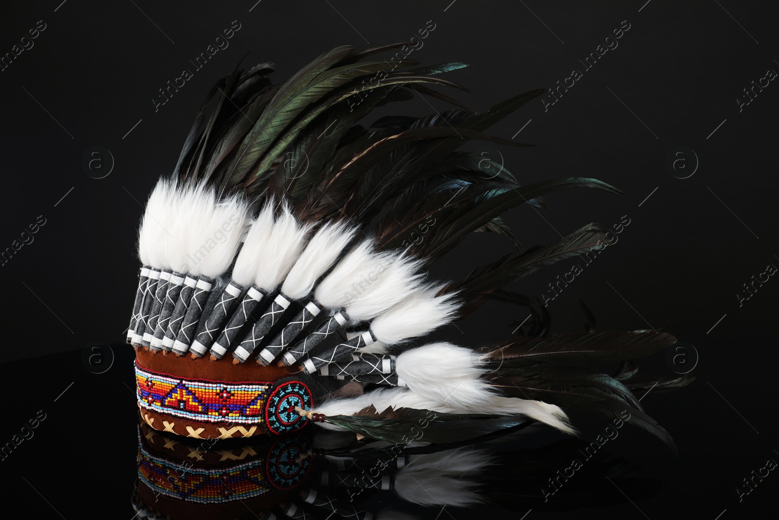 Photo of Traditional warbonnet (Native American chief headdress) on black mirror surface