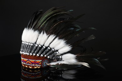 Photo of Traditional warbonnet (Native American chief headdress) on black mirror surface