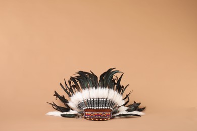 Photo of Traditional warbonnet (Native American chief headdress) on beige background