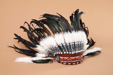 Photo of Traditional warbonnet (Native American chief headdress) on beige background