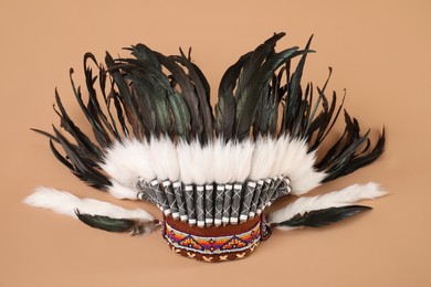 Photo of Traditional warbonnet (Native American chief headdress) on beige background