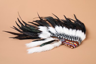 Photo of Traditional warbonnet (Native American chief headdress) on beige background