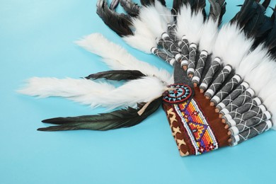 Photo of Traditional warbonnet (Native American chief headdress) on light blue background